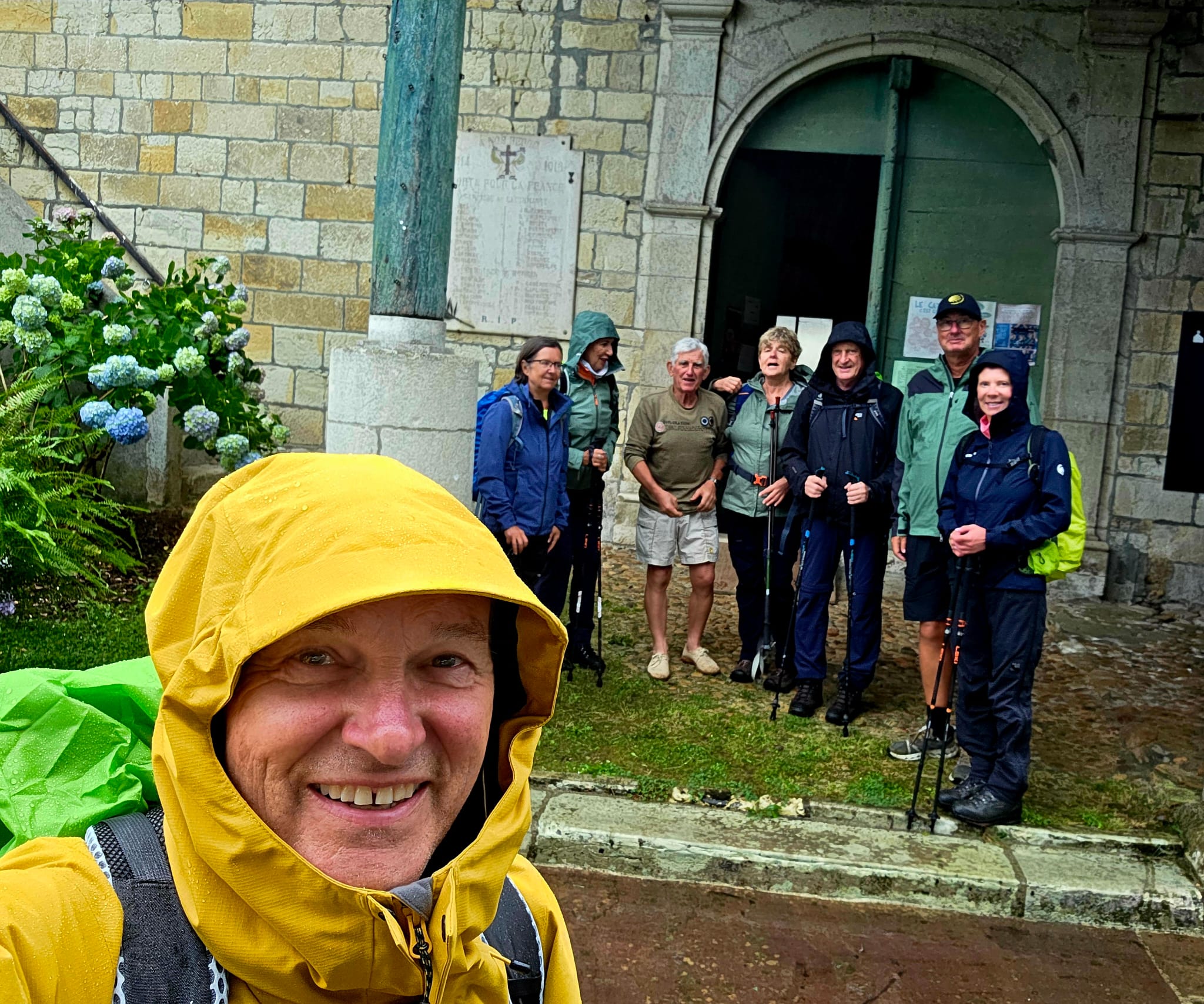 groep wandelaars in de regen met regenkledij aan